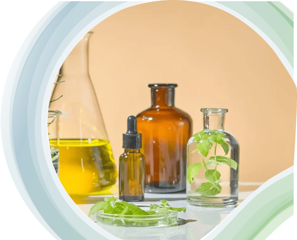 Various glass bottles with liquids and herbs on a circular tray.
