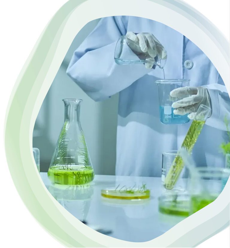 Scientist conducting experiments with green liquid in a lab.